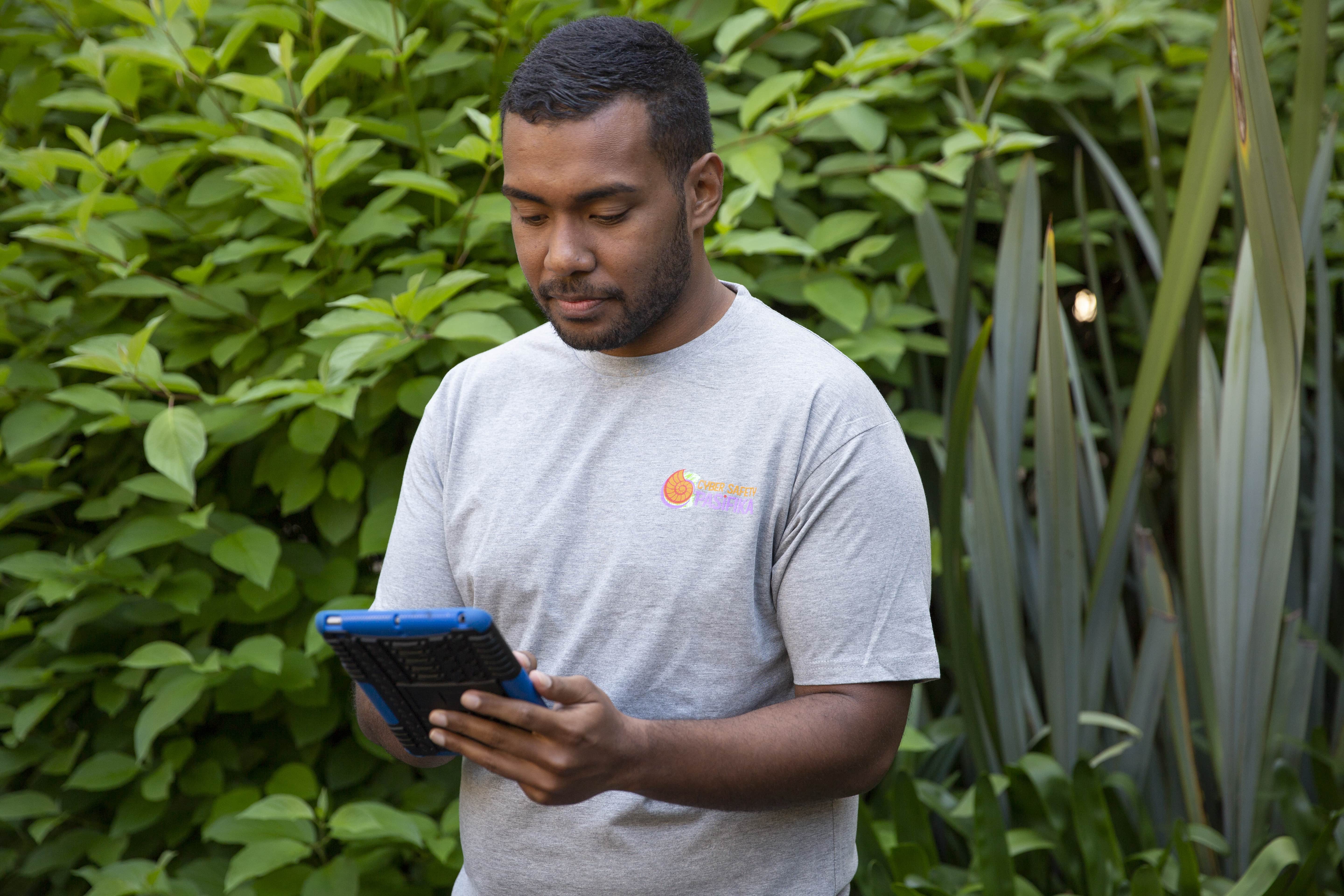 Young male using his tablet device to access information