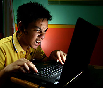 cyberbully angry at a computer screen